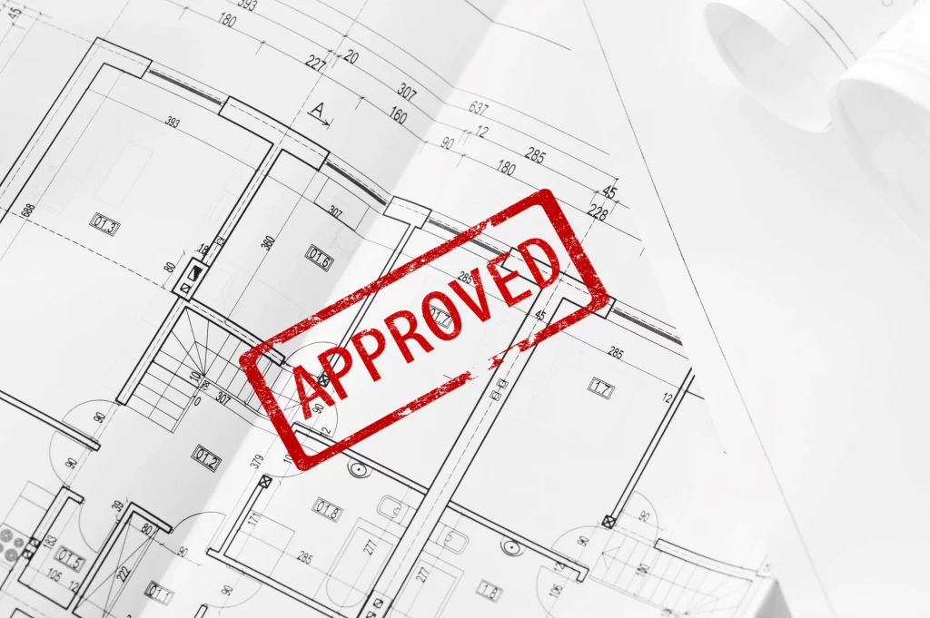Architect holding approved planning documents for a new construction project
