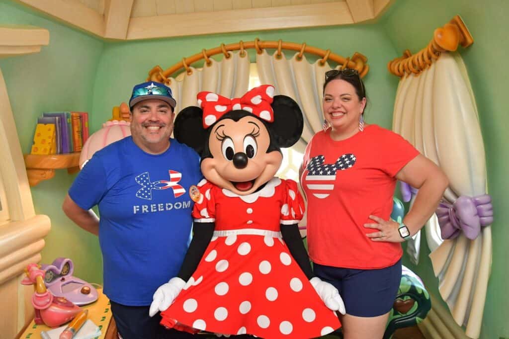 Cheerful couple with Minnie Mouse character at Disney-themed vacation rental, family-friendly Disney vacation getaway, Orlando Florida.