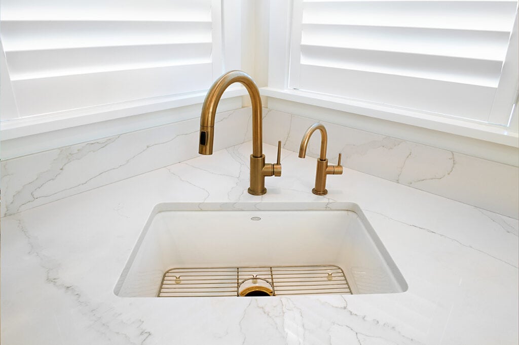 Deltas Trinsic kitchen faucet and matching beverage faucet in Champagne Bronze