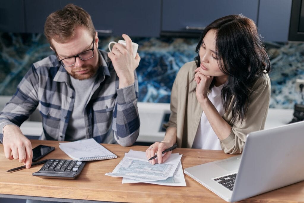 A Couple Discussing Finance and Paperwork with a Calculator