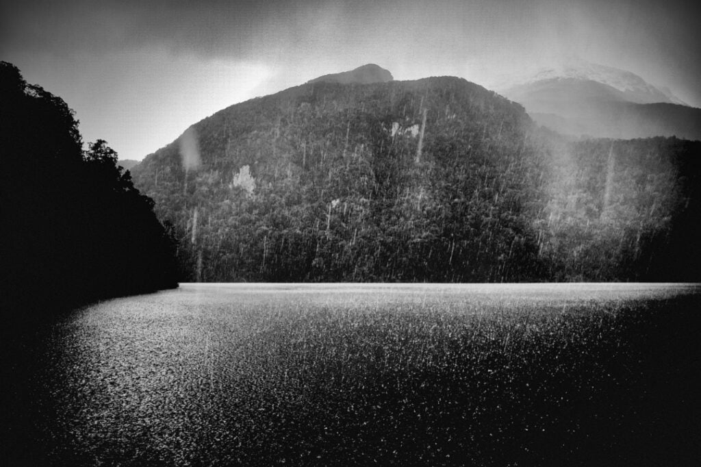Long Sound Fiordland NZ – snow flakes settling on water. B&W