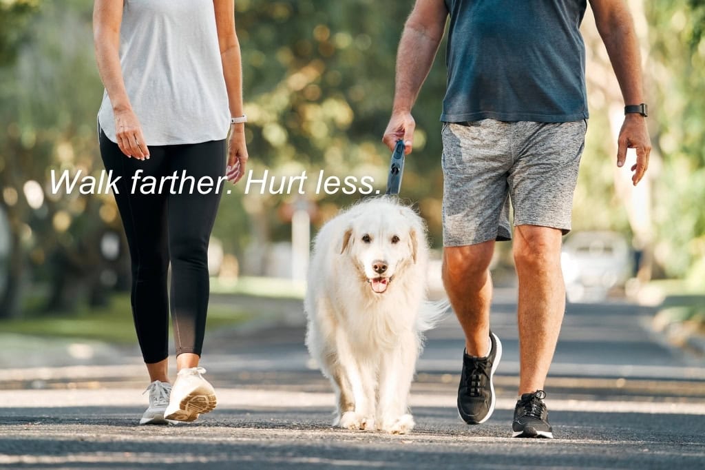 Middle-aged woman and man comfortably walking their dog after a successful vein procedure. Text on image reads 'Walk farther. Hurt less."