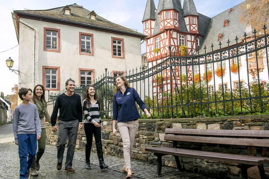 Charming group walking through historic town with colorful architecture and scenic surroundings.