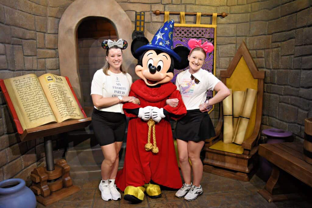 Disney characters with guests at a themed attraction.