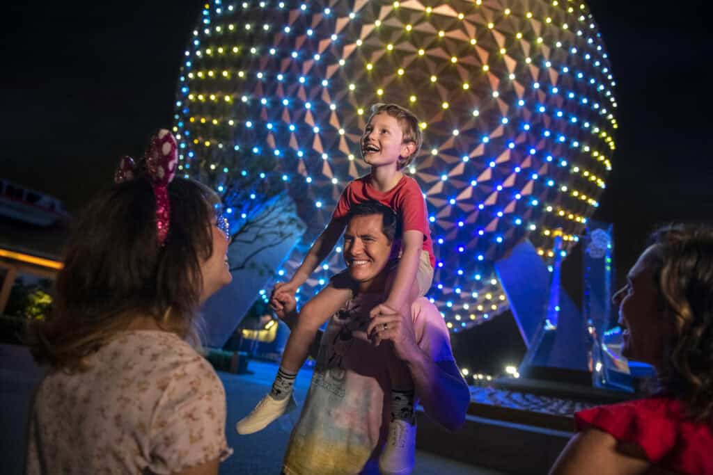 407vacations-family enjoying nighttime at Epcot illumination.