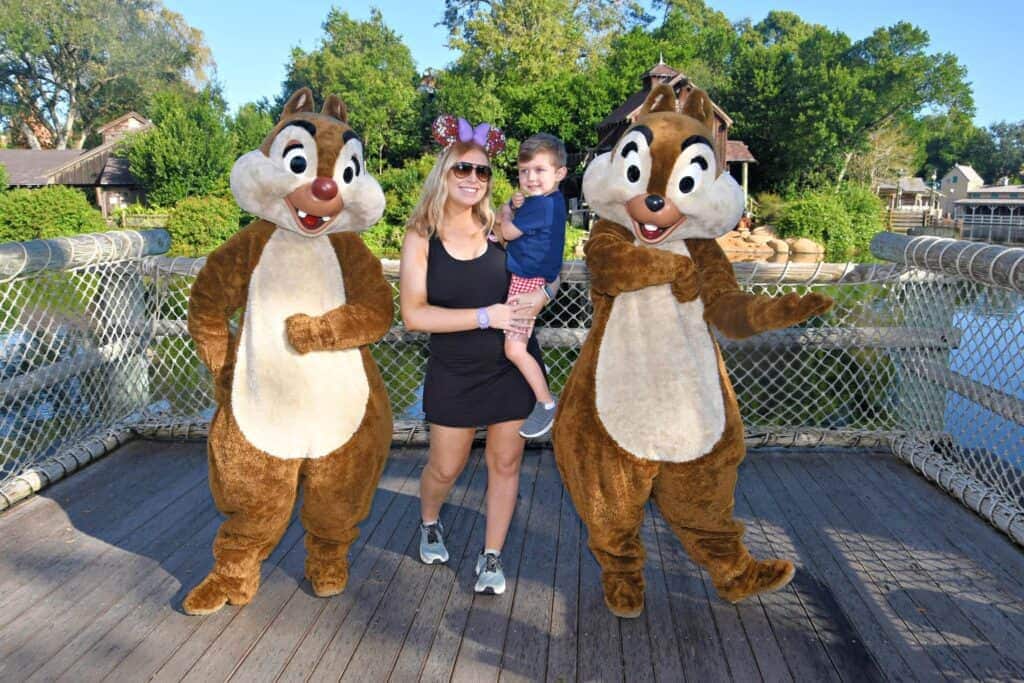 Colorful Disney-inspired Mickey Mouse ear headband with floral details and purple bow, perfect for amusement park visits.