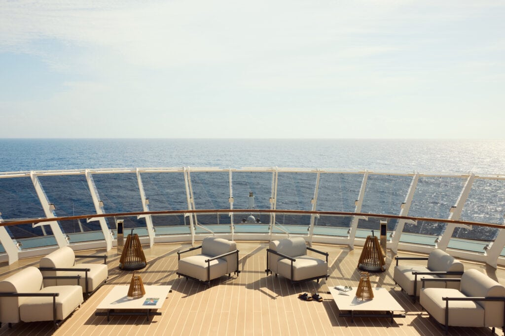 Luxury cruise deck with comfortable seating and ocean view for relaxing vacations.