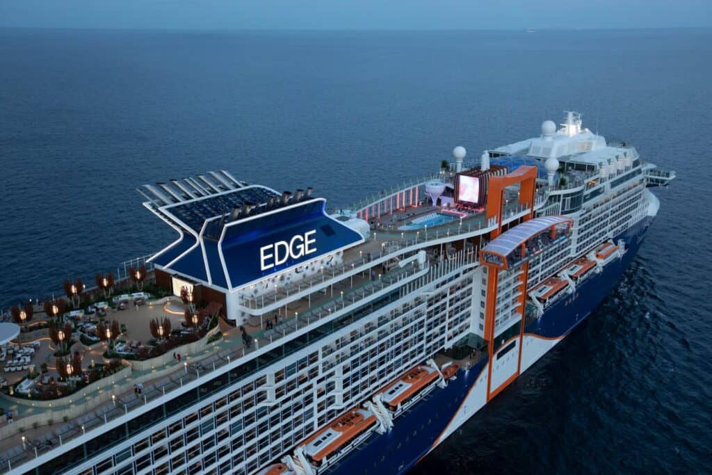 Edge cruise ship at sea with outdoor deck and amenities.