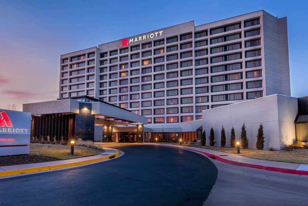 Modern Marriott hotel exterior at sunset with welcoming entrance.