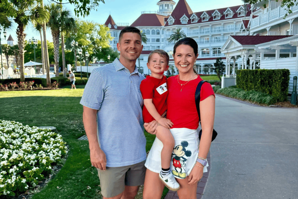 Family at Disney World resort with iconic architecture and lush gardens.