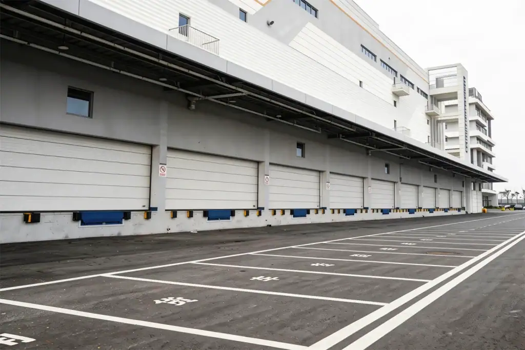 Large-scale logistics park project featuring heavy-duty industrial sectional doors and dock levelers, supplied by our expert sectional doors manufacturer team.