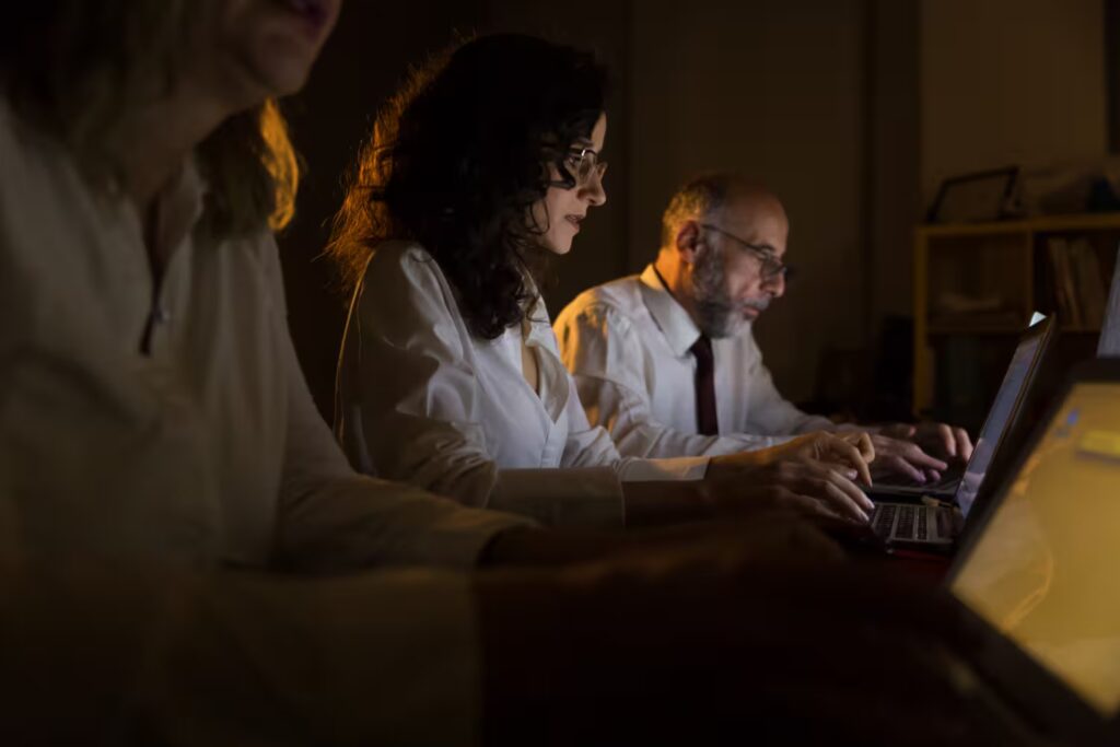 Team analyzing data on laptops—collaborative business strategy, analytics dashboards, and data-driven decision-making.