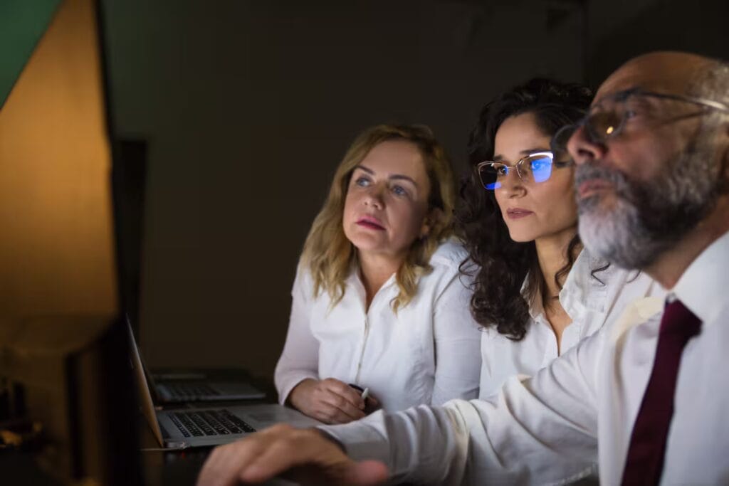 Financial strategy team working late in modern office
