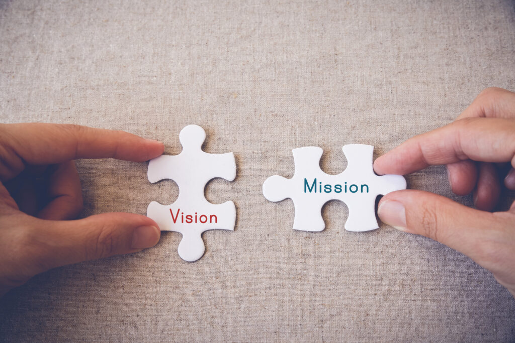Hands holding puzzle pieces with HR vision and mission text