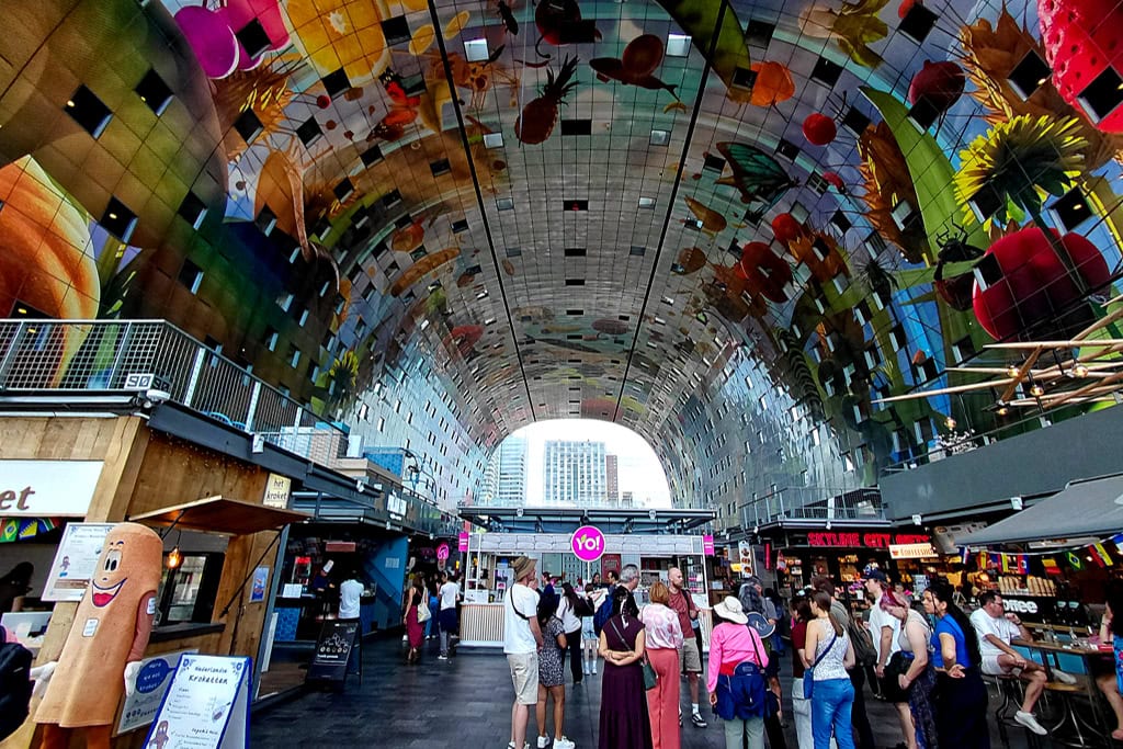 Inside the Markthal, the gigantic ceiling installation by Arno Coenen and Iris Roskam called Horn of Plenty depicts oversized fruits,'n'flowers.