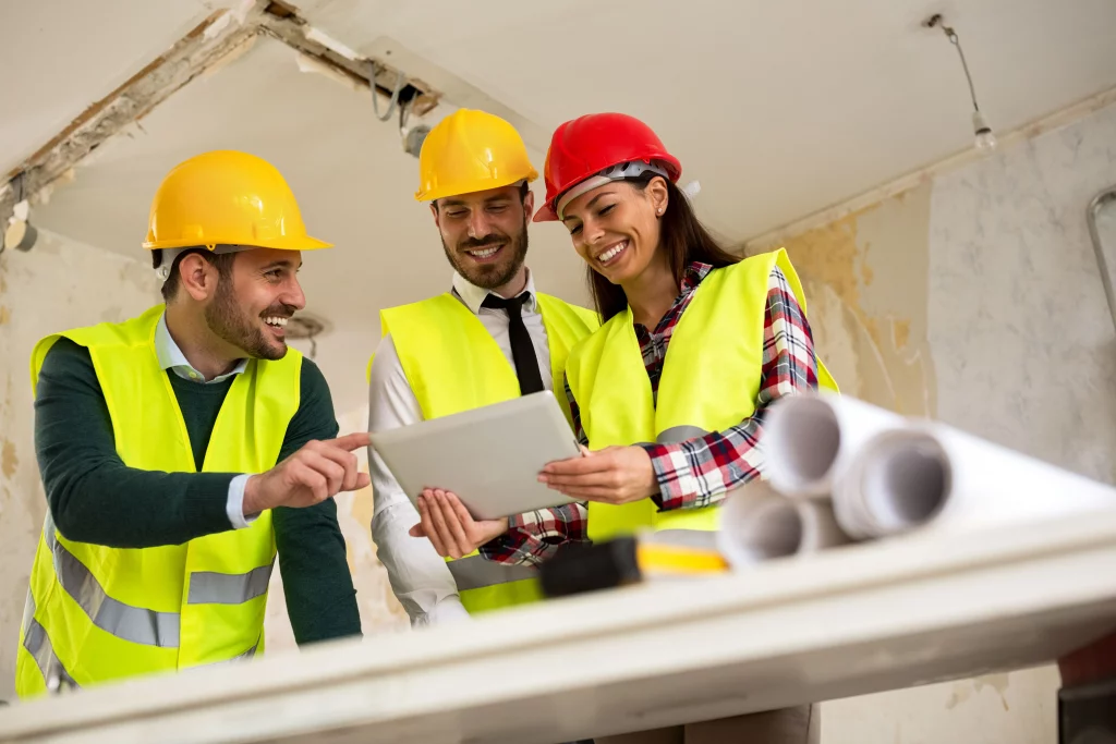 Construction site with cranes, workers, and steel framework representing the construction industry