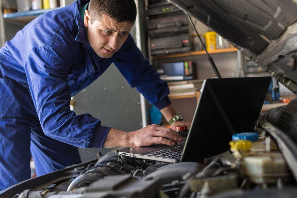 Mechanic checking car ECU