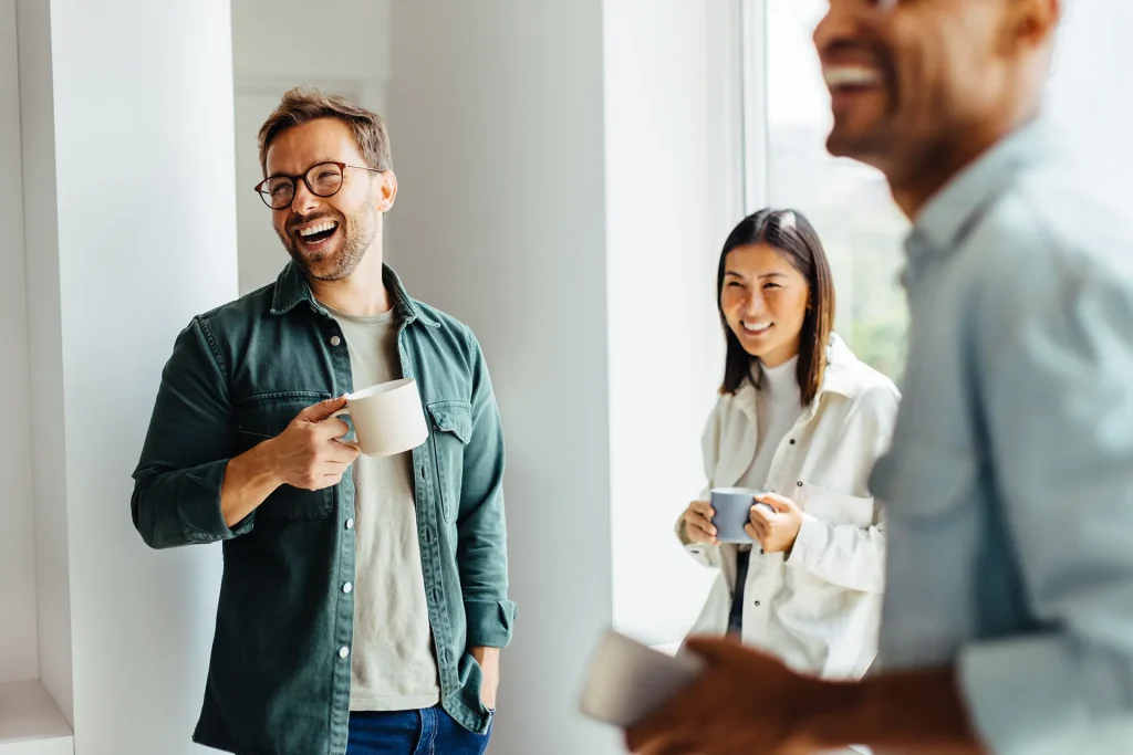 Happy business people taking a coffee break at work
