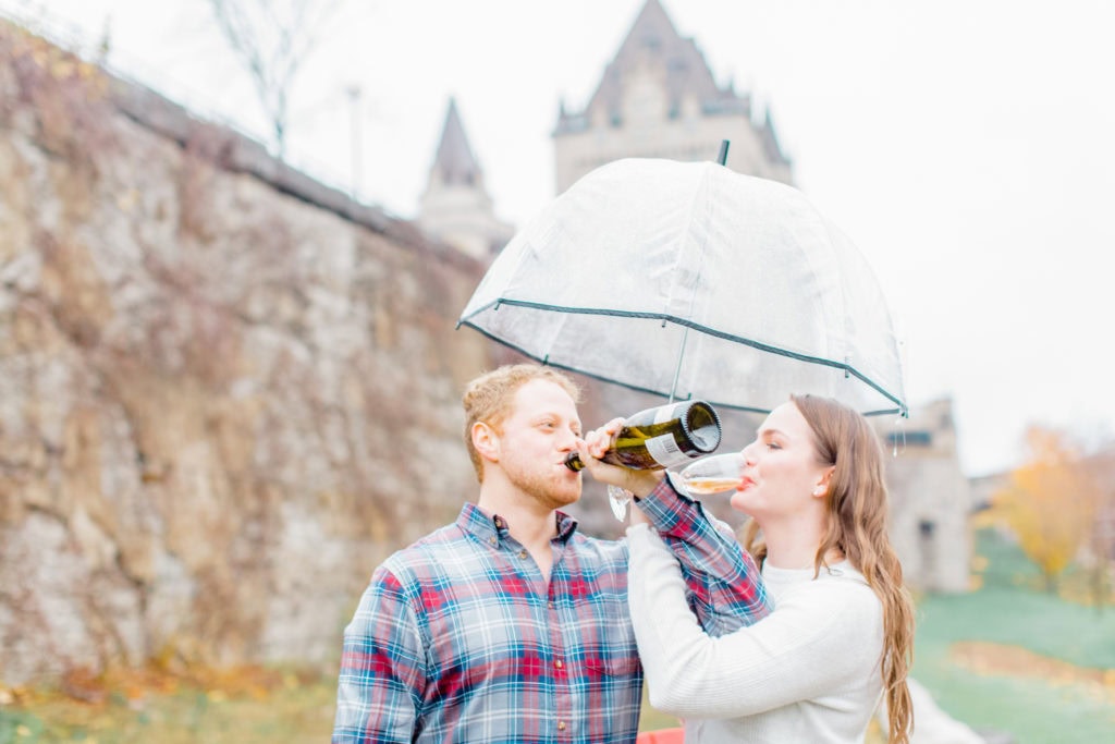 fall Engagement Session Downtown Ottawa during Sunset National Art Gallery grey loft studio ottawa wedding photographer videographer engagement kanata orleans nepean beautiful locations for engagement photos in ottawa chateau laurier majors hill park pop champagne pink and black dress rainy day engagement session using clear umbrella