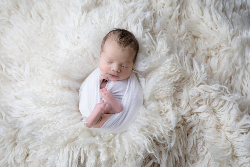 newborn baby boy posed in a professional photo studio in ottawa carp grey loft studio photographer cute family session newborn photographer ottawa