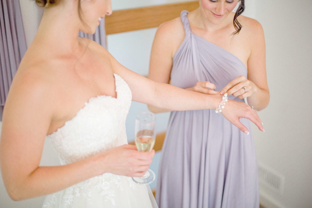 Bride getting help during Getting Ready - Lavender Rain Inspired Wedding - Le Belvedere- Grey Loft Studio- Ottawa Wedding Photographer - Affordable - Cheap - Fine Art - Best - Kanata Photographer - Wedding Videographer Ottawa - Light and Airy - Beautiful - Timeless - Organic Photographer Carp - Stittsville