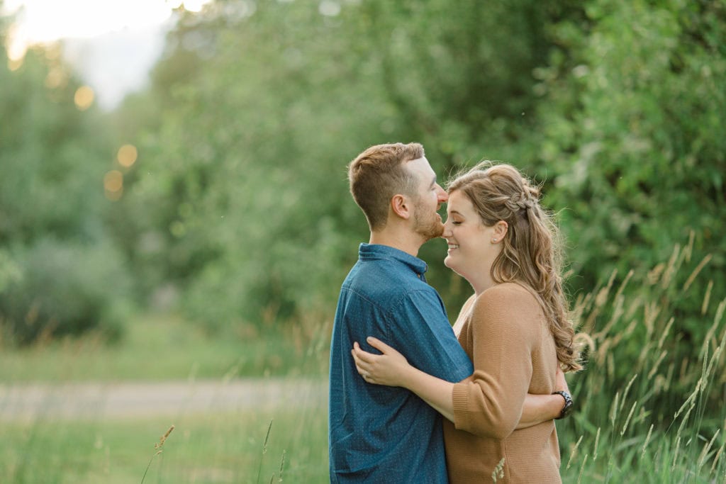 Poses during Engagement Session Sunset - Natural Posing for Photo Session - Couples Photo Session Fun - Fun on the Farm - Farm Engagement Session - Blue and Brown Engagement Session Inspiration - Natural Engagement Session Posing - Ideas for what to wear for Engagement Photography, Modern Engagement Session Inspiration Wardrobe Ideas. Unsure of what to wear for your engagement photos, we've got you! Romantic brown with black leggings for Summer Engagement in Almonte. Grey Loft Studio is Ottawa's Wedding and Engagement Photographer for Real couples, showcasing photos that are modern, bright, and fun.