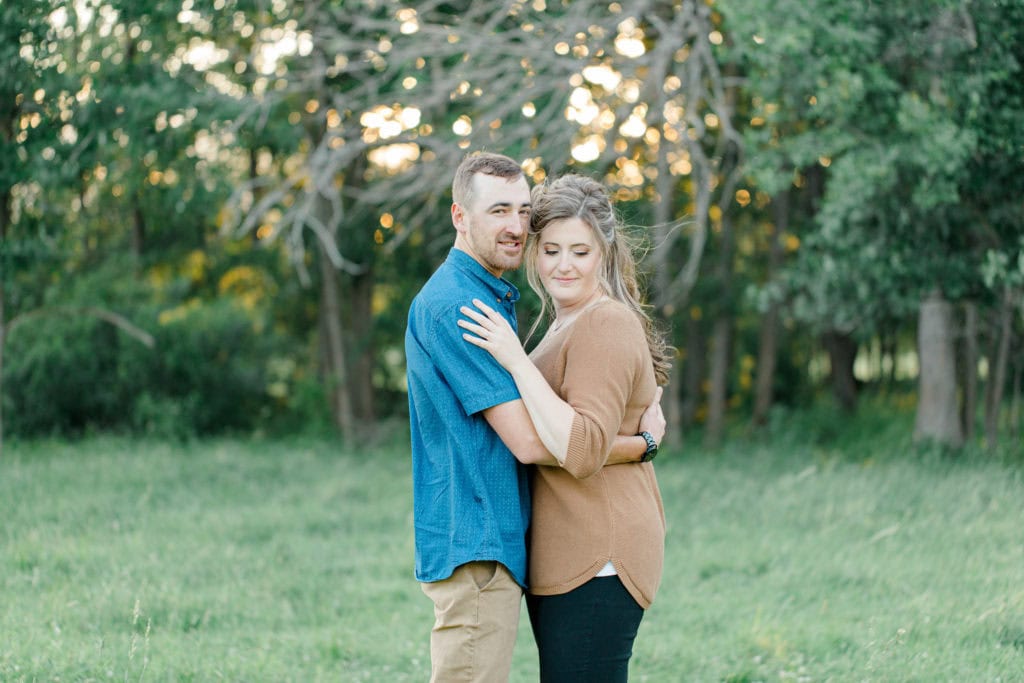Cows during Engagement Session - Poses during Engagement Session Sunset - Natural Posing for Photo Session - Couples Photo Session Fun - Fun on the Farm - Farm Engagement Session - Blue and Brown Engagement Session Inspiration - Natural Engagement Session Posing - Ideas for what to wear for Engagement Photography, Modern Engagement Session Inspiration Wardrobe Ideas. Unsure of what to wear for your engagement photos, we've got you! Romantic brown with black leggings for Summer Engagement in Almonte. Grey Loft Studio is Ottawa's Wedding and Engagement Photographer for Real couples, showcasing photos that are modern, bright, and fun.