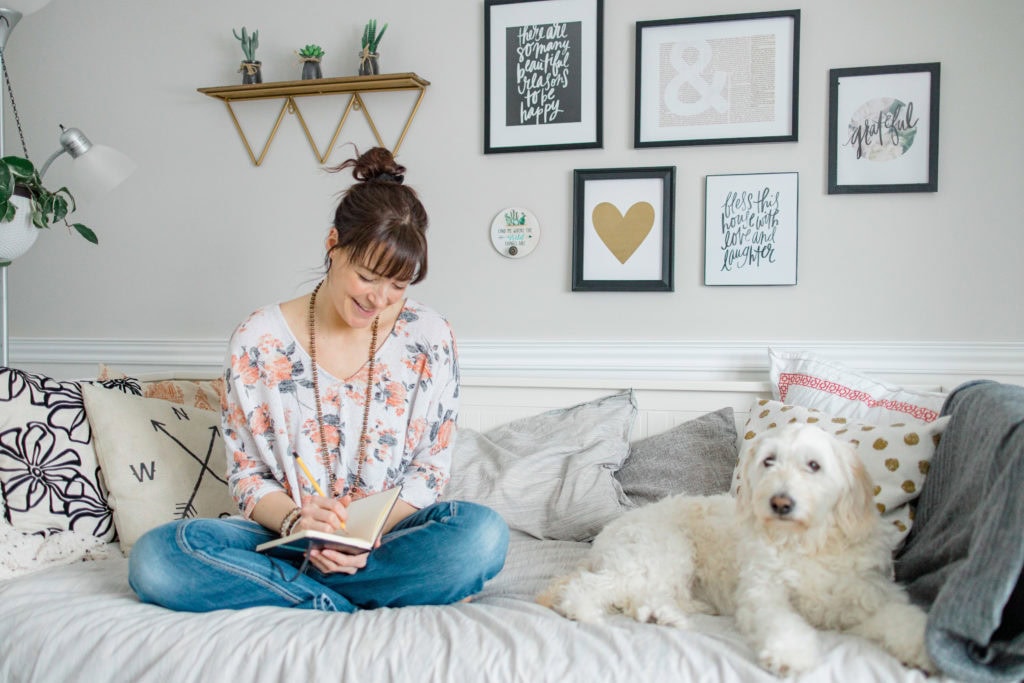 Jennifer sitting on Daybed with Dog Journalling during Branding Session- Path to Business Podcast - Episode 23: Jennifer Hall - Psychic Medium - Channeling your Deceased Loved Ones and Spirit Guides & Empowering you to FIND and Trust Intuition