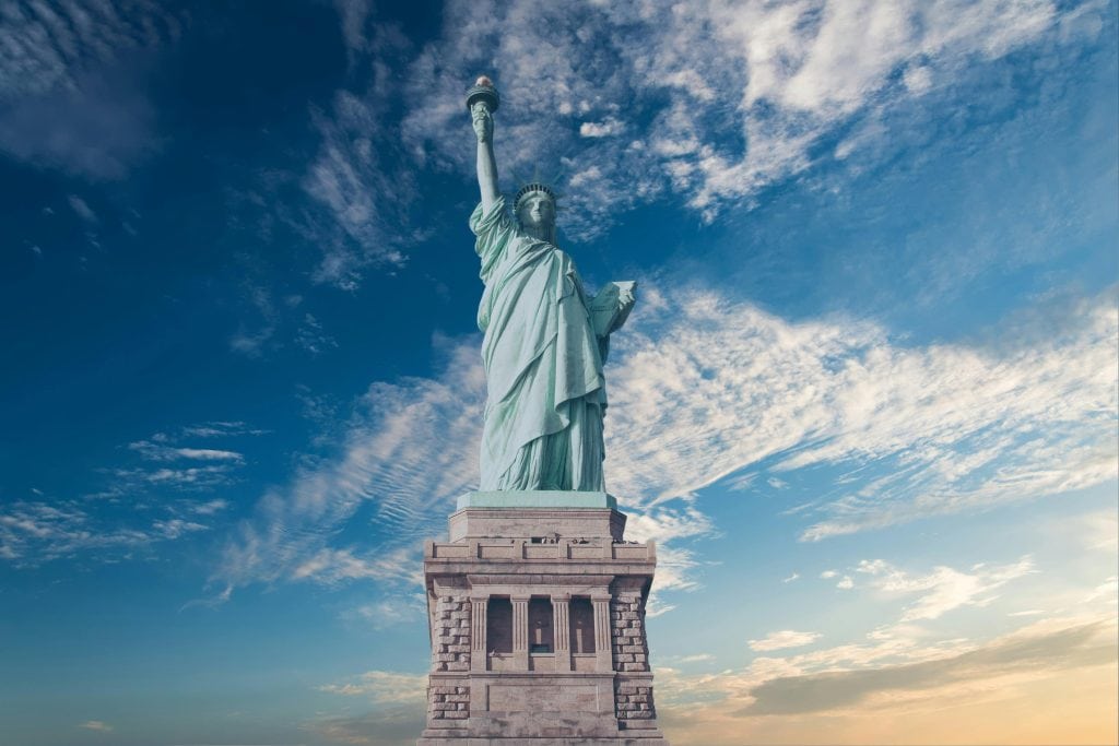 “Adventure traveler exploring iconic destinations across the top 10 states to visit in the USA, from mountains to vibrant cities.”