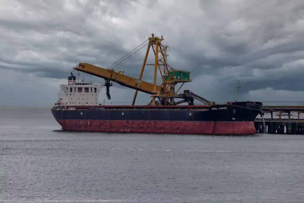 Bulk carrier at a loading terminal under a storm sky