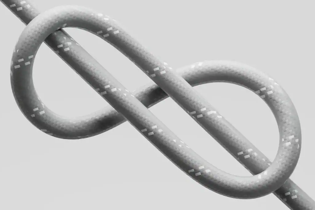 Grey rope tied in a figure-eight knot on a light background