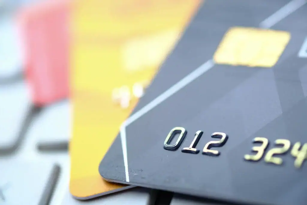 A photo showing three cards on top of one another, resting on a keyboard.