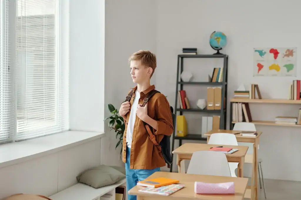 A confident student standing in a classroom, depicting the benefit of a Personalised Tutor.