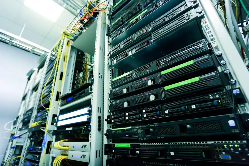 Close-up of a data centre server rack with dense cabling, representing the physical hardware powering websites and cloud storage
