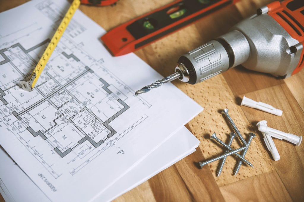 a blueprint of renovations drill and nails