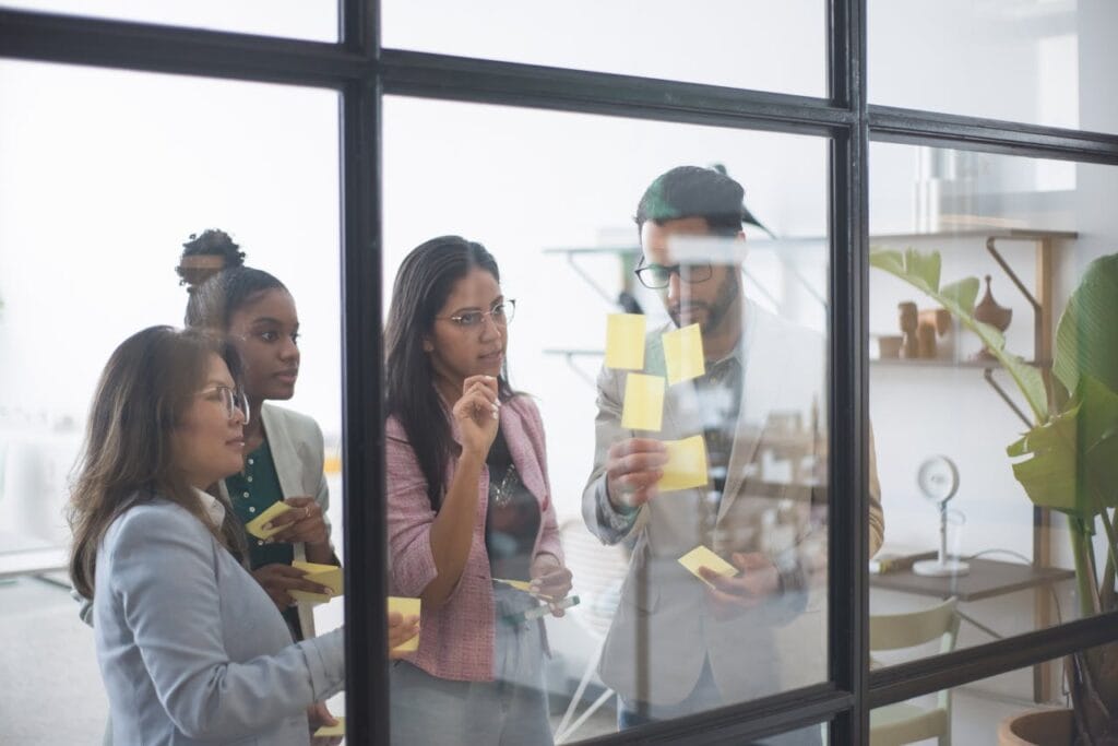A Group of People in a Meeting Discussing with Some Sticky Notes