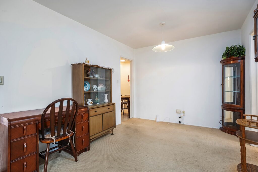 Dining area at 1751 39th St, San Diego, showing a vintage hutch and access to the functional kitchen