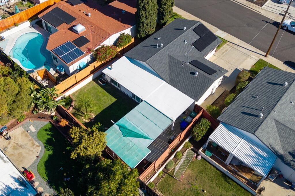 Aerial bird's-eye view of the backyard at 2170 Montclair St in North Park, featuring a green lawn and covered patio area.