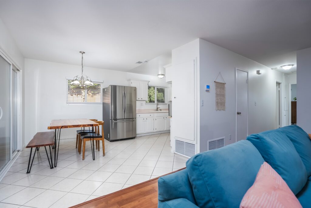 View of the open-concept dining area and kitchen at 2170 Montclair St in North Park with recessed lighting and natural wood accents.