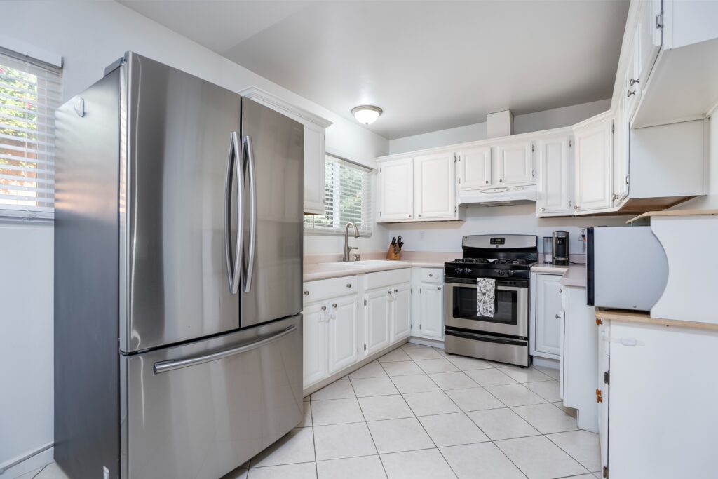 Alternative view of the kitchen at 2170 Montclair St in North Park, showing the appliances and cabinets