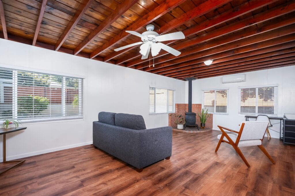 Sun-filled bonus room at 2170 Montclair St North Park with exposed Knotty Pine ceilings and antique potbelly stove.
