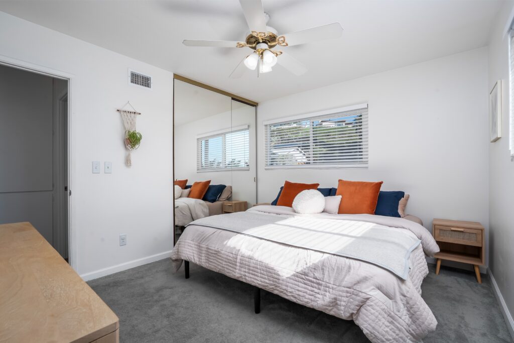 Primary bedroom interior at 2170 Montclair St showing a large mirrored closet and natural light, located in the McKinley Elementary boundary of North Park.