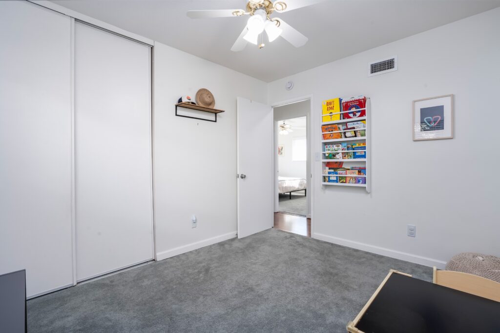 View of a bedroom at 2170 Montclair St North Park showing a built-in closet and hallway access, highlighting the home's clever storage solutions.