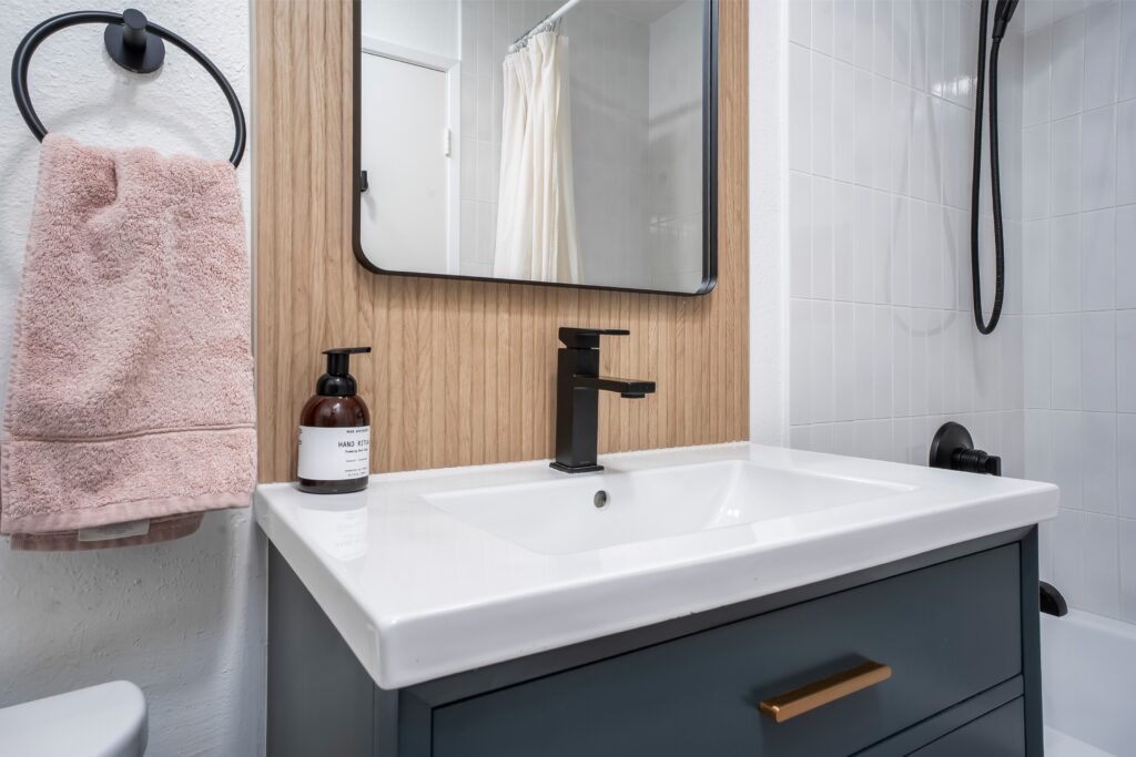 Close-up of a modern vanity and black faucet at 2170 Montclair St, in one of the property's remodeled bathrooms.