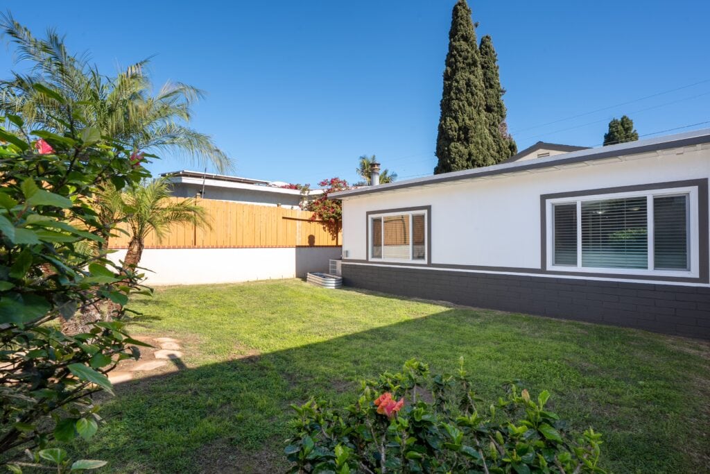 Exterior view of 2170 Montclair St North Park real estate, featuring updated double-pane vinyl windows and a modern white-and-grey color palette