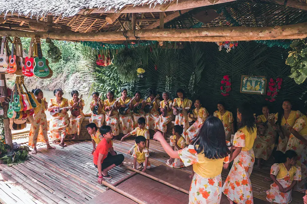 A picture of children dancing a traditional dance, on a Loboc Floating Restaurant, in Loboc, Philippines.