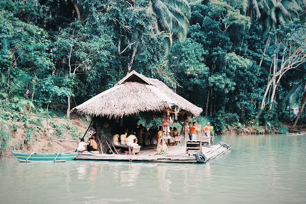 A raft floating on the Loboc River with a social gathering onboard. What a life style!