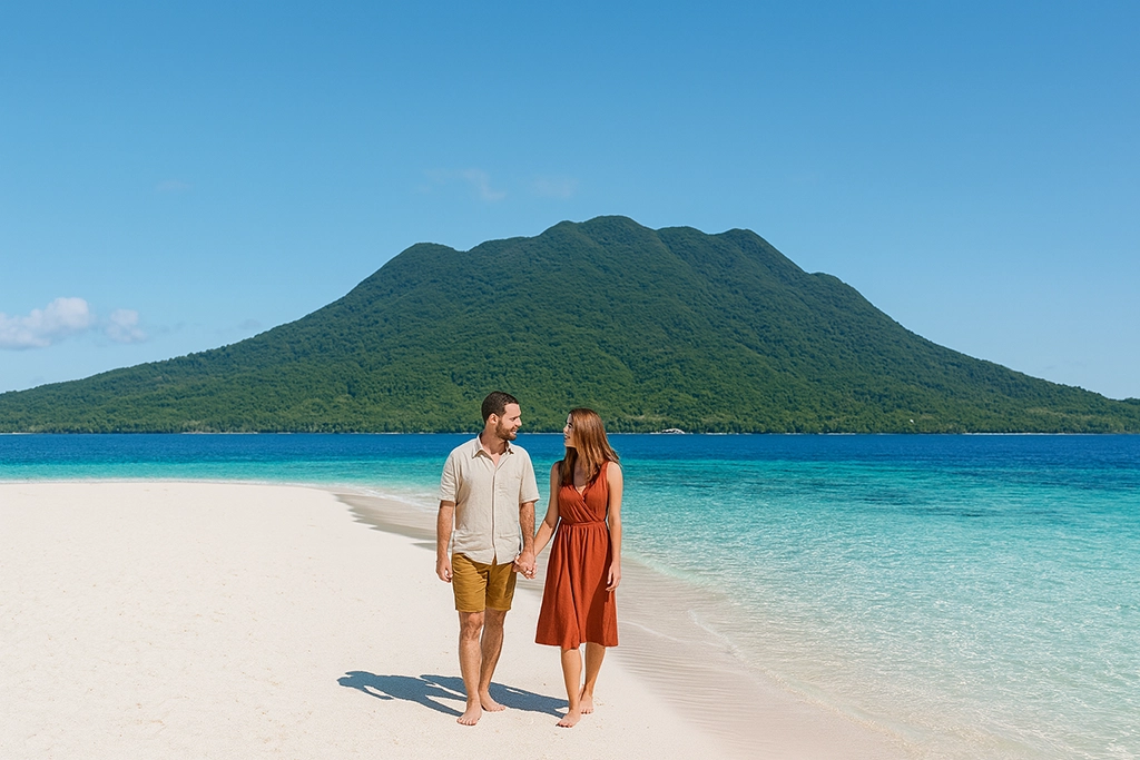 Couple on White Island sandbar with volcano view in Camiguin.