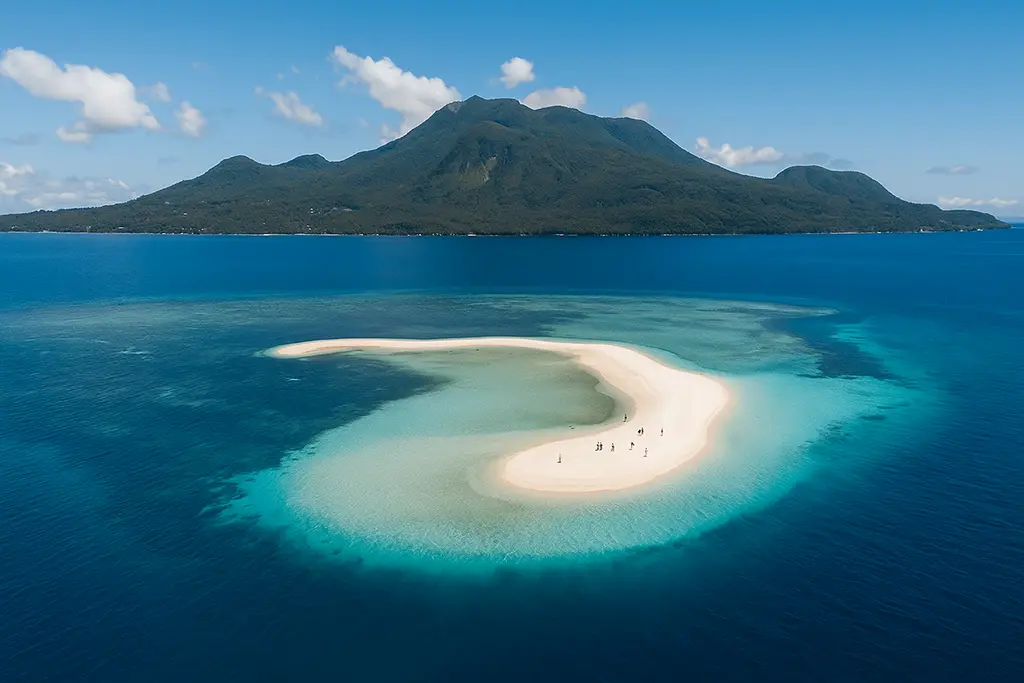 Camiguin White Island sandbar with volcano.