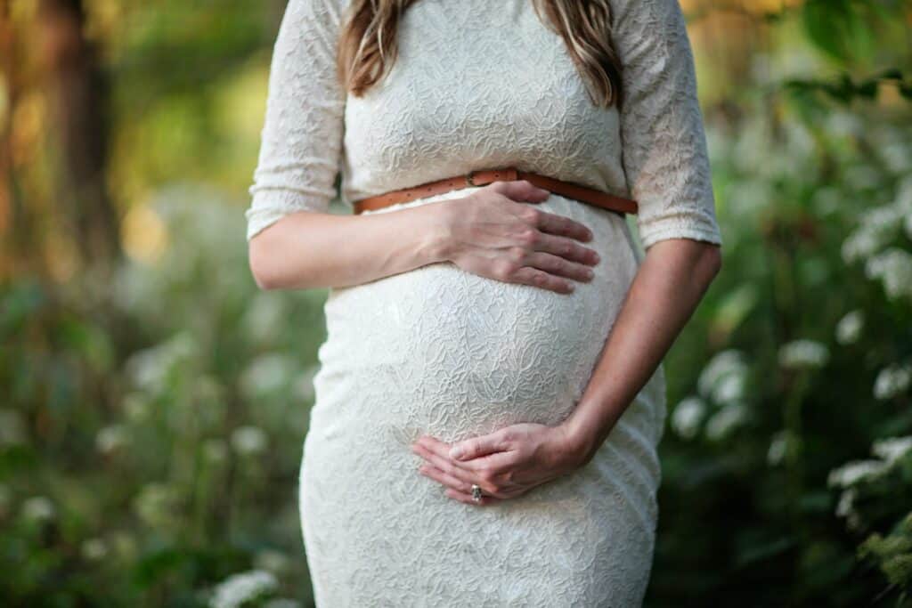 A pregnant woman in a dress related to maternity leave